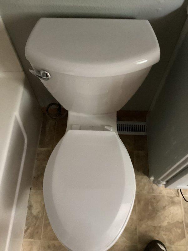 Responded to a water leak complaint where the basement PVC drain pipe was dripping when the main floor toilet was flushed. Upon inspection, determined the toilet was leaking due to a failed wax ring seal at the base. Removed and reset the toilet with a new wax ring, eliminating the leak and restoring proper drainage function.
