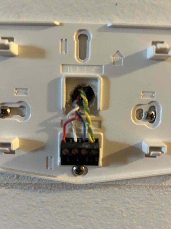 Replaced defective thermostat with new S40 smart thermostat under parts warranty. Removed old thermostat, installed new base plate with proper wire terminations (R, Y, G, C wiring), mounted S40 unit, configured system settings, and established remote access functionality on homeowner's mobile device for complete system control.