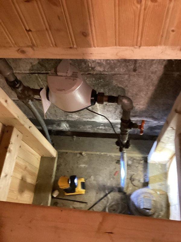 Responded to water leak emergency where sink shut-off valve was inoperative and main water line shut-off valve had failed. Upon assessment, determined that the main valve required municipal water shut-off to safely complete repairs. Coordinated with city utility department to shut off water supply at the meter. Replaced failed 3/4" copper first valve to restore proper water control and prevent future leaks. Accessed plumbing system through crawl space beneath wooden flooring, working among existing copper piping and mechanical infrastructure. Successfully restored water shut-off capability at the fixture location, eliminating the active leak condition and providing reliable isolation valve operation for future maintenance needs.