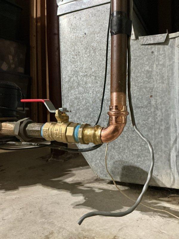 Completed comprehensive plumbing inspection and identified a leaking main water valve requiring immediate replacement. Flushed hot water tank as part of routine maintenance protocol. Removed deteriorated 3/4" gate valve and copper 90-degree elbow fitting from the main water line. Installed new 3/4" brass ball valve with red handle, making proper connections to existing copper piping. Tested all connections and verified no leaks present. All plumbing systems confirmed operational and functioning properly upon completion.