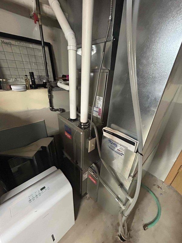 Completed comprehensive AC tune-up and system inspection on residential HVAC equipment. Performed standard maintenance procedures on air handler unit, documented equipment make, model, and serial number information with detailed photographs as requested due to unknown system age. Verified proper operation of all mechanical components, condensate drain lines, and ductwork connections. System operating within normal parameters upon completion of service.