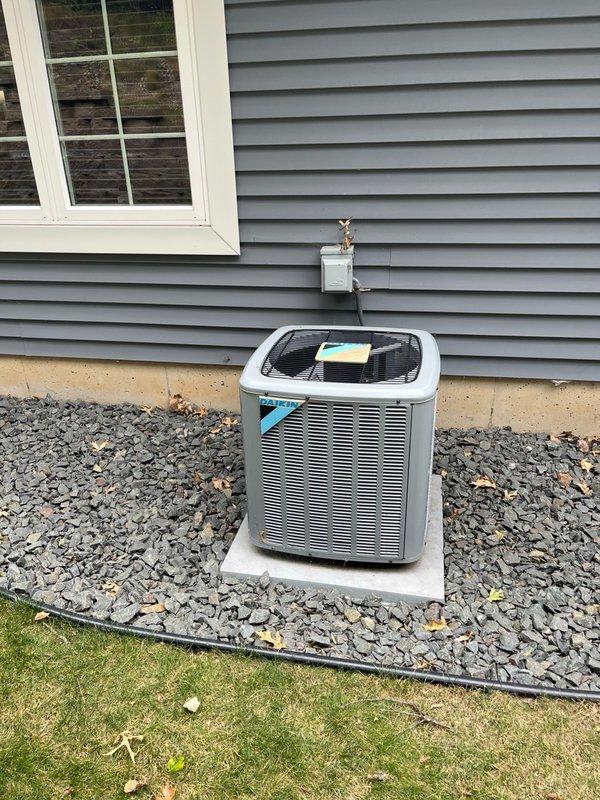 Performed comprehensive AC tune-up on 8-year-old system with no customer concerns reported. Discovered air filter significantly plugged and temporarily replaced with 16x25x5 filter from stock; indoor blower and evaporator coil found clean with proper condensate drainage. Inspected outdoor condenser unit, verified all components clean, and confirmed electrical readings within manufacturer specifications including capacitor, contactor, and wiring connections. Conducted operational testing with 15-minute runtime, verified system performance with temperature split exceeding 18°F across evaporator coil. Recommended permanent filter replacement during scheduled fall furnace inspection to coordinate with annual maintenance routine. System operating properly with no deficiencies requiring immediate attention.