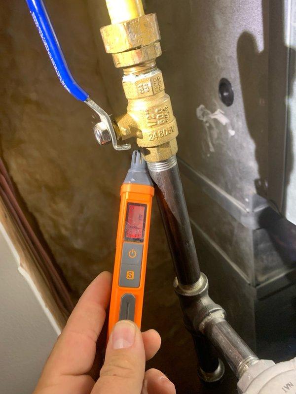 Responded to reports of natural gas odor in mechanical room of 11-year-old furnace system. Performed comprehensive inspection of gas supply lines, fittings, and connections using combustible gas detector. Identified two active leaks: one at the main ball valve connection and a second at the drip leg assembly. Tightened loose connections at ball valve to manufacturer specifications and replaced defective 1/2" cap on drip leg. Conducted leak verification testing on all gas connections and fittings to confirm repairs. Cycled furnace through complete heating operation to verify system functionality and monitor for any additional gas migration. All connections tested leak-free and system returned to normal operation.
