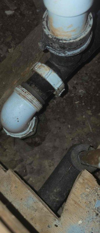 Responded to water leak emergency with water penetrating through garage ceiling from overhead bathtub drain line. Upon investigation, identified severely corroded galvanized pipe section as the source of the leak. Removed the deteriorated galvanized piping and installed new replacement section with proper rubber couplings and stainless steel hose clamps to ensure watertight connections. Verified all connections were secure and tested the drain system to confirm leak was eliminated and proper drainage restored.