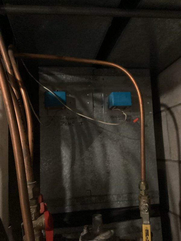 Completed comprehensive AC and furnace tune-up for residential HVAC system experiencing inadequate cooling in upstairs zone. Performed diagnostic evaluation of 32-year-old condensing unit revealing low R22 refrigerant charge confirmed through system pressure assessment and refrigerant level verification. Identified undersized condensing unit as contributing factor to insufficient cooling capacity for residence. 

Conducted furnace inspection confirming proper operation with safe combustion parameters, clean air filters, and appropriate temperature splits across heat exchanger. Discovered deficiencies in existing zone damper system including improper wiring and loose electrical connections requiring attention.

Measured electrical parameters using digital multimeter to verify system performance and diagnose control issues. Documented equipment condition through photographic evidence showing aged furnace with copper refrigerant lines and worn components consistent with three decades of o