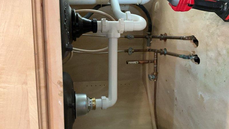 Responded to service call for non-functioning garbage disposal in kitchen. Upon inspection, determined disposal unit was inoperable and required replacement. Removed existing garbage disposal and installed new sink basket assembly in white double-basin kitchen sink with granite countertop. Verified proper drainage and tested all connections for leaks. Completed installation of disposal flange and strainer assemblies in both basins, ensuring secure mounting and proper seal. All fixtures left in working order with no drainage issues detected.