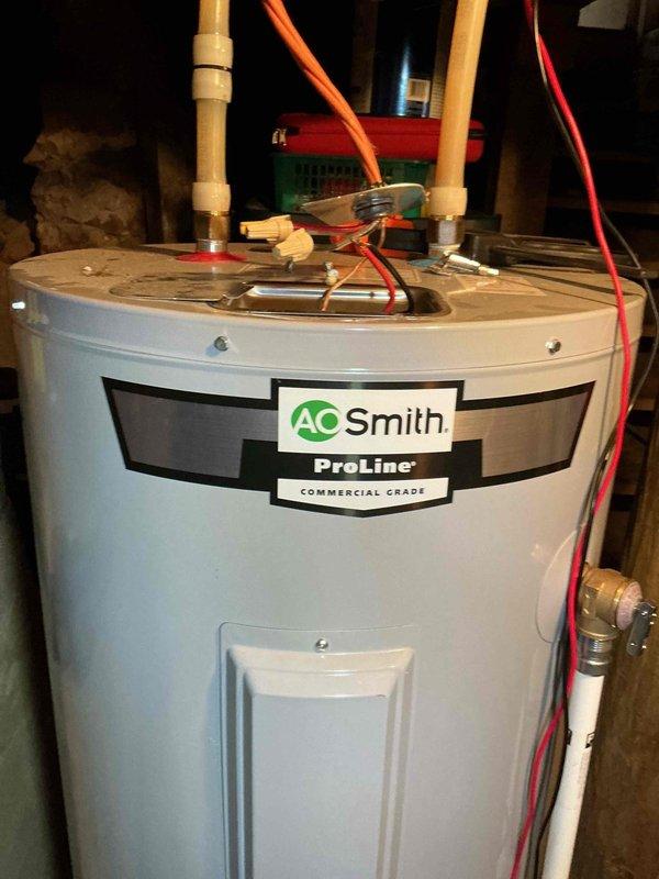 Responded to no hot water complaint on 2-year-old AO Smith ProLine Commercial Grade tanked water heater with circuit breaker tripping issues. Upon arrival, tested voltage at breaker and found only 120V instead of required 240V. Cycled breaker multiple times, initially reading 90V, then eventually restored to 240V temporarily. Determined electrical supply issue at breaker panel requires licensed electrician for proper diagnosis and repair of inconsistent voltage delivery to water heater circuit. Scheduled electrical contractor to address breaker or panel connection fault causing intermittent power loss to unit.