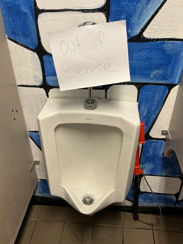 Responded to service call for clogged wall-mounted Kohler urinal that would not drain. Upon arrival, found unit already marked out of service. Applied chemical drain treatment (Sizzle) and agitated the blockage to restore proper drainage. Verified flush valve operation and confirmed urinal returned to normal function.