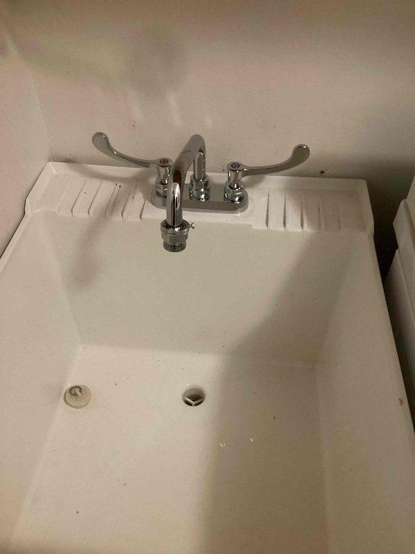 Installed customer-supplied laundry faucet on utility sink and company-supplied tub spout. Installation completed without complications, with all fixtures properly mounted and secured. No issues encountered during the installation process, and all replaced items are functioning as intended.