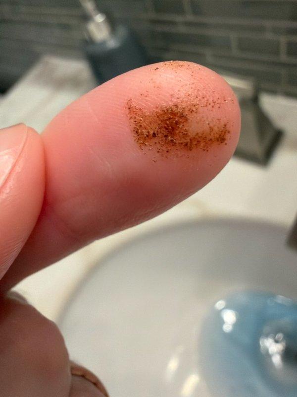 Responded to customer complaint of brownish sediment accumulating in bathtub after running hot water. Upon inspection, confirmed presence of fine granular sediment in hot water lines and identified improper installation of existing 3-year-old gas water heater. Documented sediment samples showing reddish-brown particulate matter consistent with internal tank corrosion and deterioration. Customer had previously attempted flushing the water heater twice with minimal improvement. Diagnosed that improper installation has accelerated sediment buildup and compromised unit performance. Provided estimate for replacement with 10-year Bradford White water heater installed to manufacturer specifications and code requirements to resolve ongoing sediment issues and ensure proper system operation.