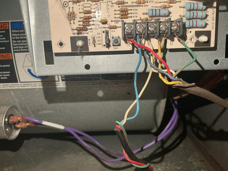 Responded to no cooling complaint on 15-year-old central air conditioning system. Upon inspection, diagnosed failed furnace control board with no voltage output to blower motor. Identified inducer draft motor leaking exhaust gases and condensation, creating potential safety hazard. Documented existing conditions with photos showing motor assembly and control board wiring configuration. Sourced replacement control board and scheduled return visit. Completed control board replacement and restored power to blower motor. Performed additional diagnostic testing to verify proper system operation following board replacement. System returned to normal cooling operation with all safety controls functioning properly.