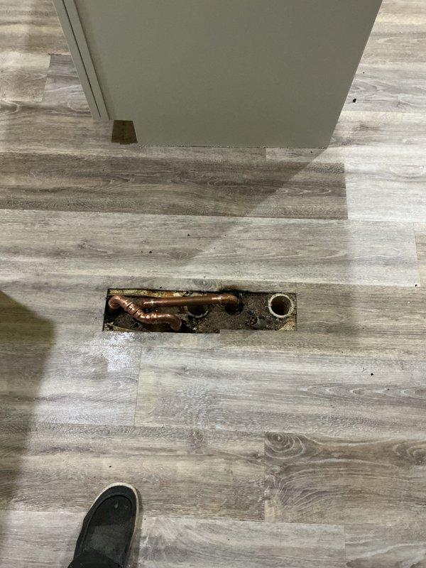 Responded to service call to inspect gas system and plumbing connections. Conducted thorough gas leak testing throughout the property with negative results. Identified and corrected exposed metal on gastite fitting to ensure proper installation standards. Re-tested all gas connections after repair to verify system integrity. In basement utility area, reconnected water supply pipes running beneath toe kick space that had become disconnected. All plumbing connections secured and tested for proper operation.