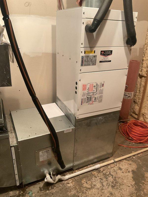 Performed comprehensive tune-up service on two air conditioning systems. Inspected both air handlers and cleared condensate drain lines. Addressed significant water accumulation on mechanical room floor by thoroughly flushing and clearing the condensate drain system on the unit in the mechanical room. Drain flow improved after flushing but continues to show slow drainage characteristics.

Washed both condenser units and performed full system diagnostics. Tested all capacitors and electrical components. Found capacitor on the older system reading 42.2 mfd against a rated 45 mfd specification, which remains within acceptable operating tolerance. Measured temperature drop across both systems at 29°, which is normal for high-velocity applications.

Due to the high-static, high-velocity system design, recommend using minimal-restriction air filters to reduce moisture accumulation at the coil. This drainage issue appears to be a long-standing characteristic of the system design rather than a