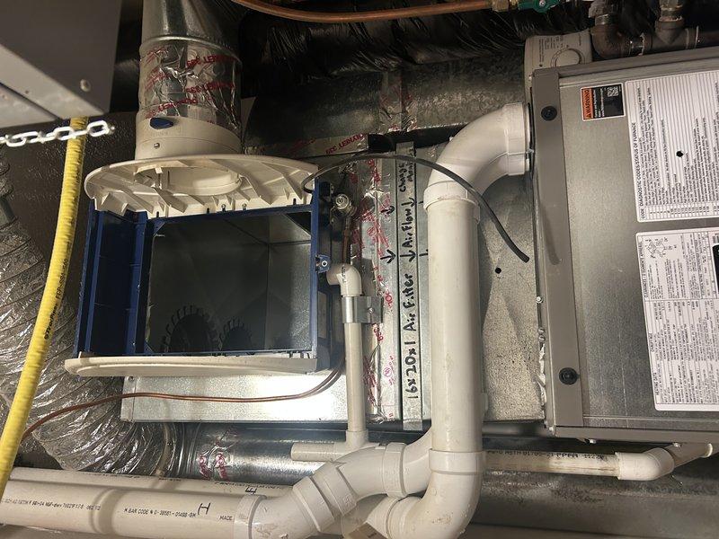 Performed furnace and AC tune-up on downflow system and identified excessive static pressure causing noisy operation and preventing second-stage heating. Measured static pressure at 1.3 inches of water column with system running at full capacity, significantly exceeding the 0.8 inch maximum rating. 

Removed humidifier cover and panel to allow system to operate properly and complete testing. Inspected all supply vents throughout home, confirming all registers open and flowing adequately. Verified air filter clean and both evaporator and condenser coils free of debris. Checked for covered or blocked returns following recent carpet installation but found none.

Tested cooling mode with humidifier components removed to prevent error codes and verify full system operation. Diagnosis confirmed inadequate return airflow due to undersized ductwork. Existing 10-inch return duct entering through floor adjacent to furnace provides limited installation space given downflow configuration.

Recomme