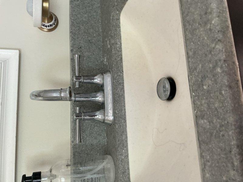 Completed comprehensive plumbing inspection of residential property identifying multiple deficiencies requiring attention. Inspected water heater and confirmed missing temperature and pressure relief valve as noted in previous home inspection report. Evaluated basement utility area plumbing system including supply lines, drainage components, and mechanical equipment connections. Assessed floor drain performance issues related to washing machine discharge, noting inadequate drainage capacity. Inspected kitchen plumbing and identified missing proper venting for drain system. Examined bathroom sink trap assembly and determined replacement needed due to improper configuration or deterioration. Documented all findings with photographic evidence showing pipe routing, fixture installations, and mechanical equipment conditions for repair recommendations and future reference.