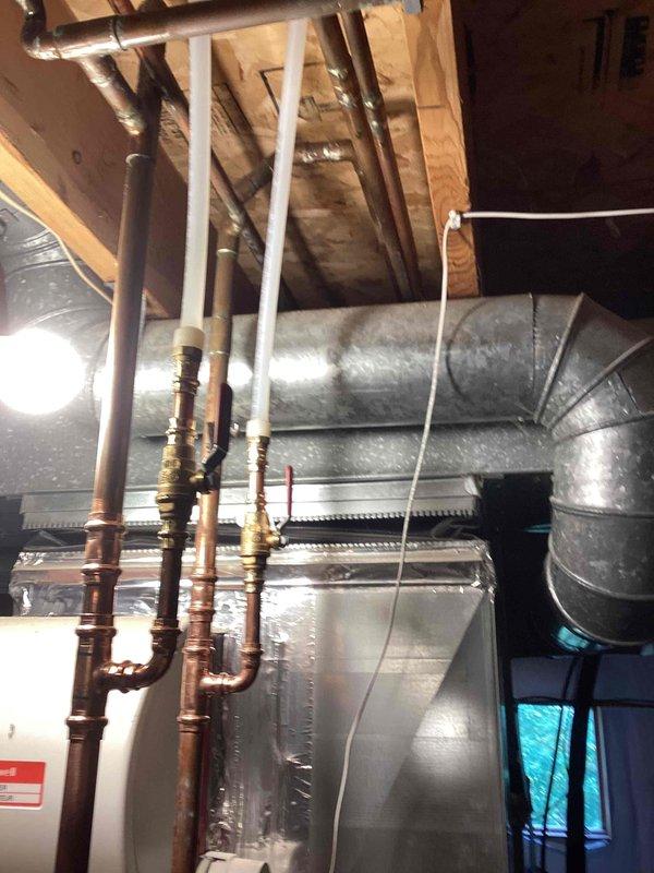 Successfully installed hot and cold water supply lines to a future bathroom location in an unfinished basement area. Ran approximately 60 feet of PEX tubing, consisting of two cold water lines and two hot water lines, routing them through the floor joists to the designated restroom area. Toilet installation was deferred to a future visit per customer request as the space was not yet ready for fixture setting.