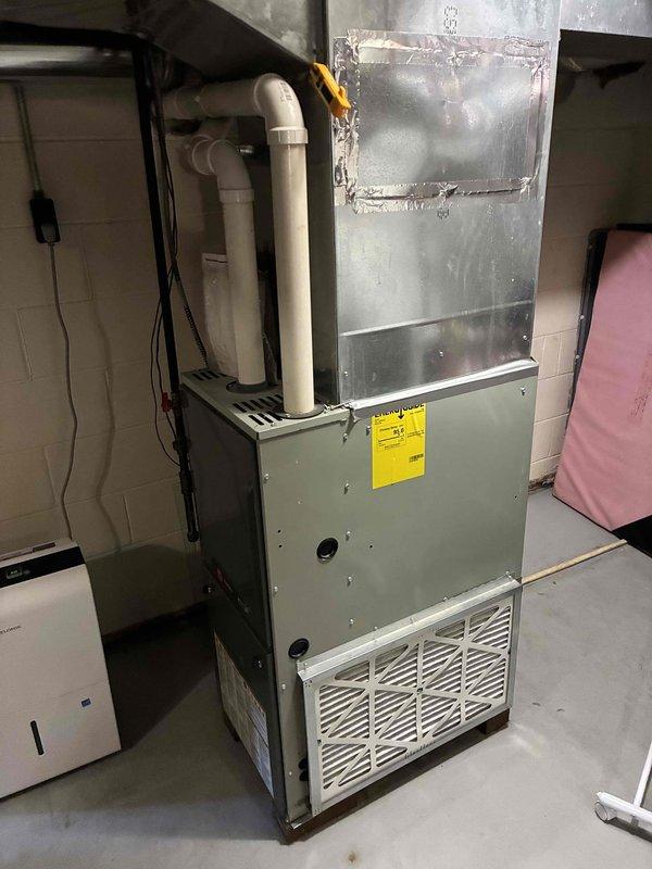 Completed preventative maintenance on 1998 R22 air conditioning system. Found condenser unit in deteriorated condition with severely bent fins restricting airflow, dual run capacitor reading 29/4 MFD (rated 35/5 MFD) indicating failure, and evaporator coil showing significant rust corrosion. Contactor tested within acceptable parameters. Verified air filter clean and condensate drain line flowing properly. Due to system age, obsolete R22 refrigerant, failed capacitor, and overall deteriorated condition of major components, recommended scheduling replacement consultation, which was arranged for following day. System remains operational but nearing end of service life.