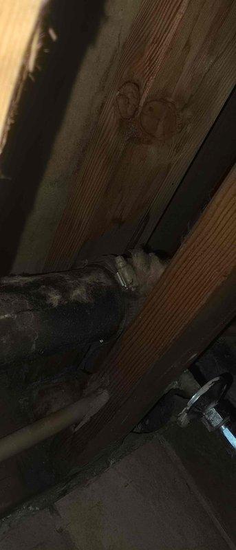 Diagnosed and assessed severely corroded cast iron mission band pipe system showing extensive rust damage and structural compromise. The existing pipe exhibited heavy oxidation with flaking layers and visible cracking throughout the affected section. Documented the deteriorated condition of the horizontal pipe run in the crawl space area, noting the advanced corrosion that had penetrated through multiple layers of the metal surface. Provided repair estimate for replacement of the compromised cast iron section with updated plumbing materials to restore proper function and prevent potential failure or water damage.