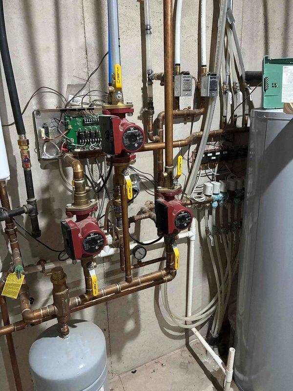 Responded to no-cooling call on Geo Comfort geothermal system. Upon arrival, found unit locked out on low pressure error. Reset system after homeowner had removed filter that had been pulled against evaporator coil. Unit ran successfully for approximately 20 minutes before shutting down on condensate error. 

Investigated condensate drainage system and discovered pan filling without draining. Cut apart and cleared condensate line which was completely obstructed with debris buildup. Inspected evaporator coil and found partial blockage. Brushed and flushed coil thoroughly to restore proper airflow and drainage. System restored to operational cooling status.

Also inspected hydronic heating system per customer request regarding overheating and zone control issues. Found multiple heating zones not shutting off properly. Upon examination, discovered evidence of recent thermostat work performed by homeowner with resulting wiring and control complications throughout multi-zone system. 

Exami