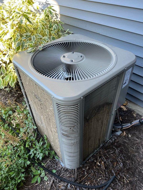 Completed annual AC tune-up and maintenance under filter replacement program. Inspected indoor blower assembly and evaporator coil, finding both clean and operating properly with adequate drainage. Performed electrical inspection on outdoor unit with all readings within manufacturer specifications. Discovered heavily plugged outdoor condenser coil, performed thorough coil cleaning to restore proper airflow and heat transfer. Replaced air filter and verified system operation with 15-minute run test, confirming temperature split exceeded 20 degrees and all components functioning normally. Recommended monthly filter replacement schedule for optimal system performance.