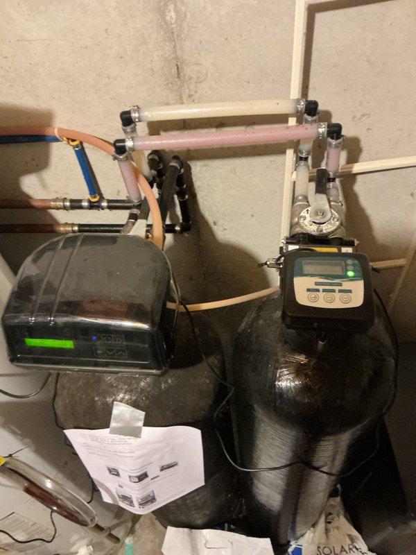 Completed biannual plumbing inspection focusing on water quality concerns and system evaluation. Customer reported sulfur odor from cold water in upstairs bathrooms and noted an exterior faucet leak that was declined for service at this time.

Performed comprehensive inspection of interior water lines and drain systems throughout the residence. Evaluated existing water treatment system consisting of dual black cylindrical filtration tanks with digital control heads and copper/PVC plumbing manifold. Inspected water heater manufactured in 2012; determined tank flushing should be deferred due to age and lack of previous maintenance history to avoid potential complications. Conducted leak detection survey of accessible plumbing fixtures and supply lines with no active leaks identified in interior spaces. All drain systems functioning properly with no blockages or slow drainage observed. Water treatment equipment operational with control displays showing active status. Documented existing s