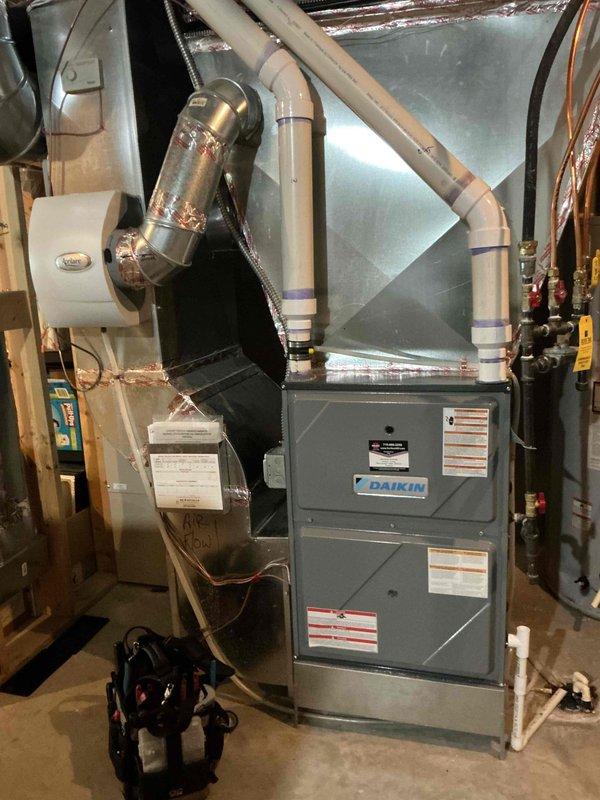 Completed comprehensive furnace and air conditioning tune-up on Daikin HVAC system. Performed full furnace inspection including heat exchanger, burners, and induced draft assembly—all components operating within specifications. Cleaned flame sensor, cleared condensate drain line, and blew out pressure switch hoses to ensure proper drainage and safety switch operation. Verified gas pressure settings and confirmed blower wheel condition. System startup demonstrated proper operation with 65° temperature rise across heat exchanger.

During furnace inspection, identified deteriorated seal between collector box and inducer motor causing minor combustion gas leak. Prepared estimate for collector box replacement to address this safety concern.

Proceeded to air conditioning maintenance, inspecting all electrical components and connections for proper operation. Flushed condenser coil to remove debris and restore optimal heat transfer efficiency. System startup confirmed proper cooling operation