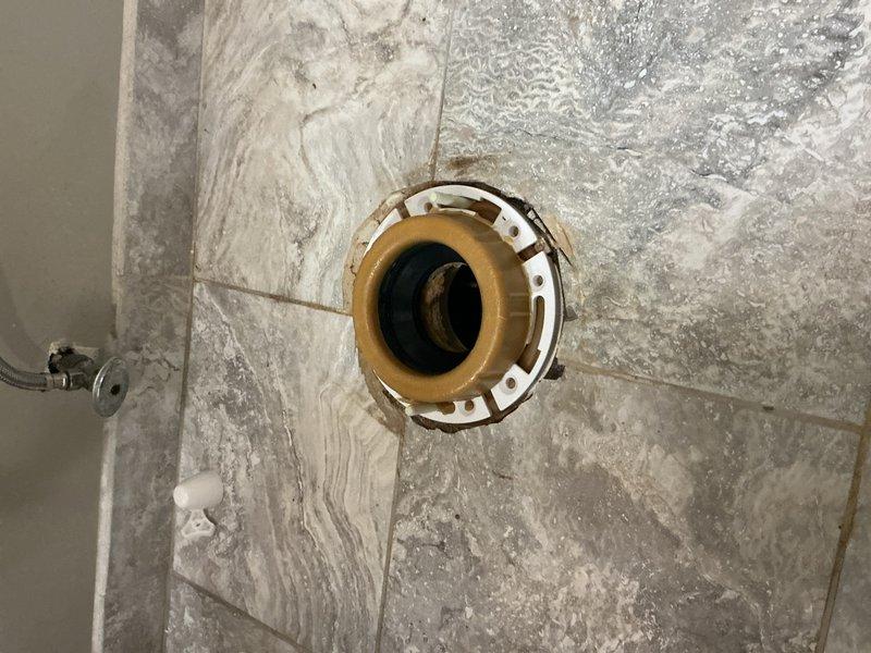 Replaced deteriorated toilet flange and built up the flange to proper height to ensure secure mounting on the tile floor. Reset toilet with new wax ring seal, verified proper alignment and stability, and confirmed leak-free operation of the fixture.