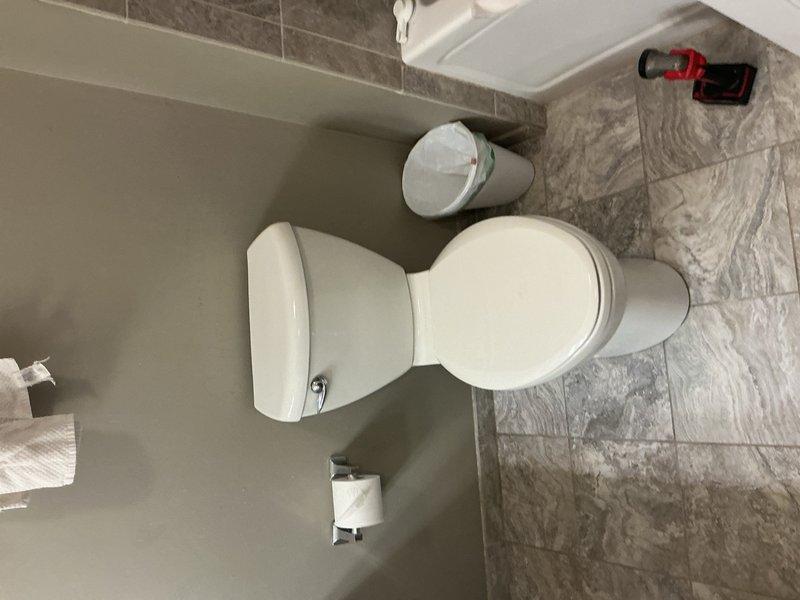 Replaced deteriorated toilet flange and built up the flange to proper height to ensure secure mounting on the tile floor. Reset toilet with new wax ring seal, verified proper alignment and stability, and confirmed leak-free operation of the fixture.