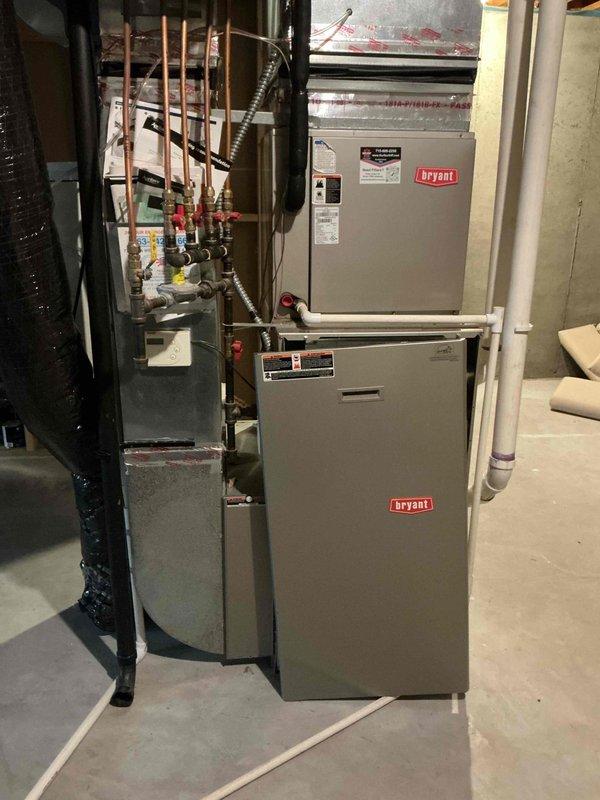 Completed comprehensive maintenance on Bryant HVAC system including both furnace and air conditioning unit. Performed furnace inspection including cleaning flame sensor, verifying condensate drainage, inspecting heat exchanger for integrity, and cleaning burners. Replaced completely plugged 20x25x1 furnace filter and AprilAire humidifier filter. Checked blower wheel operation and confirmed proper furnace operation with 45° temperature rise upon startup. Conducted air conditioning maintenance including electrical component inspection, condenser coil cleaning, and system startup verification with 18° temperature drop. All systems operating within normal parameters.