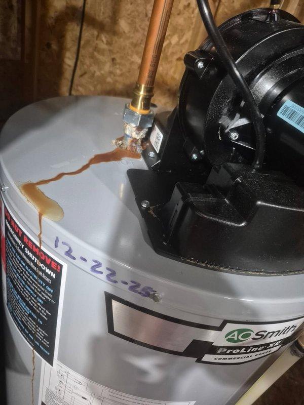 Responded to leaking water heater fittings on an AO Smith ProLine XL unit previously installed. Upon inspection, found active leaks at two top-mounted pipe connections with visible corrosion and rust staining on tank surface and drain pan. Due to ongoing water quality issues that have caused repeated service calls and equipment damage, repair work has been postponed pending water treatment evaluation and recommendations to address the root cause before proceeding with fitting repairs or replacements.