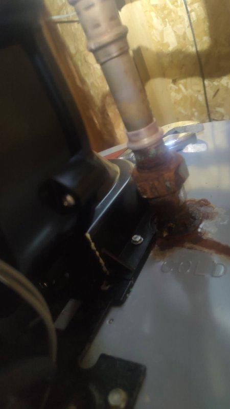 Responded to leaking water heater fittings on an AO Smith ProLine XL unit previously installed. Upon inspection, found active leaks at two top-mounted pipe connections with visible corrosion and rust staining on tank surface and drain pan. Due to ongoing water quality issues that have caused repeated service calls and equipment damage, repair work has been postponed pending water treatment evaluation and recommendations to address the root cause before proceeding with fitting repairs or replacements.