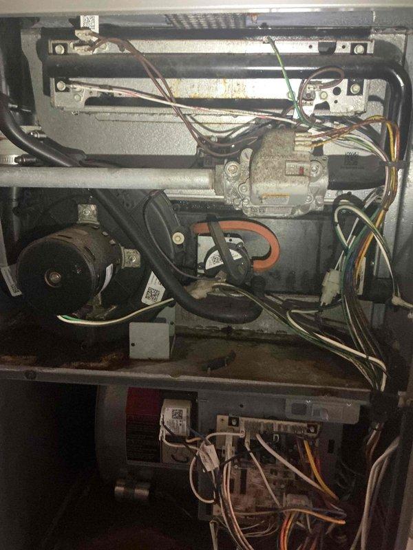 Responded to a no-cool service call on a 12-year-old Lennox HVAC system reporting no airflow and unusual buzzing noise. Upon inspection, discovered a sheared blower motor mount preventing the blower wheel from rotating freely. Further investigation revealed extensive rust damage throughout the furnace cabinet, including the heat exchanger, burner assembly, and front panel components. The severity and extent of corrosion indicates long-term moisture exposure and suggests multiple system compromises beyond the immediate blower motor failure. Advised customer that while blower motor replacement could restore airflow, the advanced rust deterioration—particularly on critical components like the heat exchanger—presents safety concerns and likely additional failures. Given the age of the unit and the comprehensive nature of the damage, recommended system replacement as the most cost-effective and reliable solution. Scheduled a service advisor consultation to provide replacement options and pr