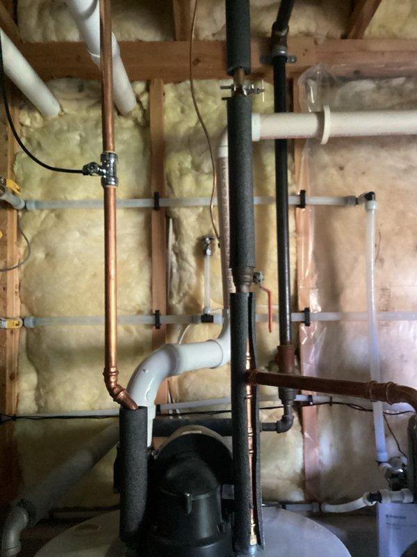 Completed comprehensive plumbing inspection of residential property, including examination of exposed plumbing infrastructure in basement area with copper and PVC piping systems, vertical waste lines, and water distribution components. Documented condition of bathroom fixtures and plumbing connections, with sprinkler valve system requiring further assessment as requested.