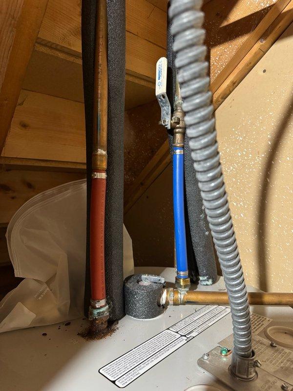 Responded to reported water heater leak and water softener malfunction at property being prepared for sale. Upon inspection, confirmed water heater was not actively leaking but discovered significant rust corrosion on hot water outlet connection. Manually initiated regeneration cycle on water softener unit, which completed successfully and appeared to be functioning within normal operating parameters. Documented rusted hot water outlet piping on tanked water heater with photographic evidence showing deteriorated copper connections at top of unit. Provided estimates for both component replacement of corroded hot water outlet assembly and full water heater replacement options for homeowner consideration.
