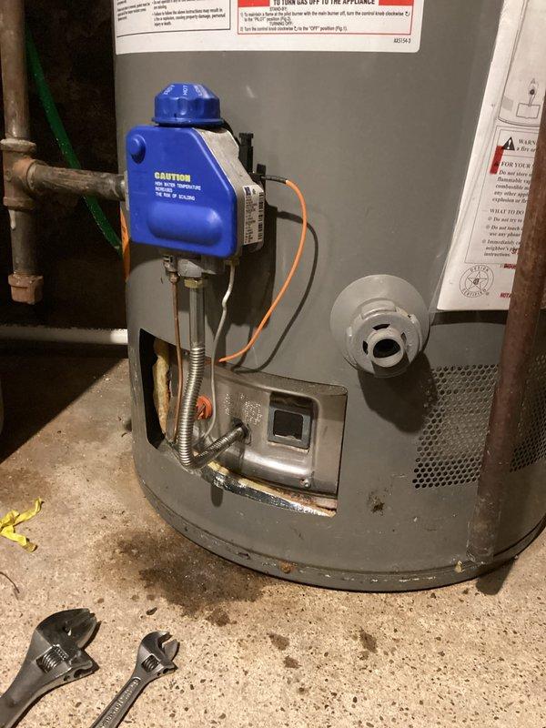 Responded to gas leak complaint at water heater following previous service calls and utility company inspection. Performed comprehensive leak detection testing and confirmed active gas leak at the gas control valve connection point and suspected secondary leak at burner assembly interface. Utility company had previously identified leaking control valve on supply pipe requiring replacement. Unit showed signs of multiple repair attempts with recently replaced gas valve still exhibiting leak issues. Conducted thorough safety inspection of all gas connections, supply piping, and combustion components. Documented leak locations with photographic evidence showing water heater installation, gas valve assembly, and associated electrical safety controls. Recommended immediate repair or replacement of faulty gas control valve and burner assembly to eliminate hazardous gas leak condition and restore safe operation.