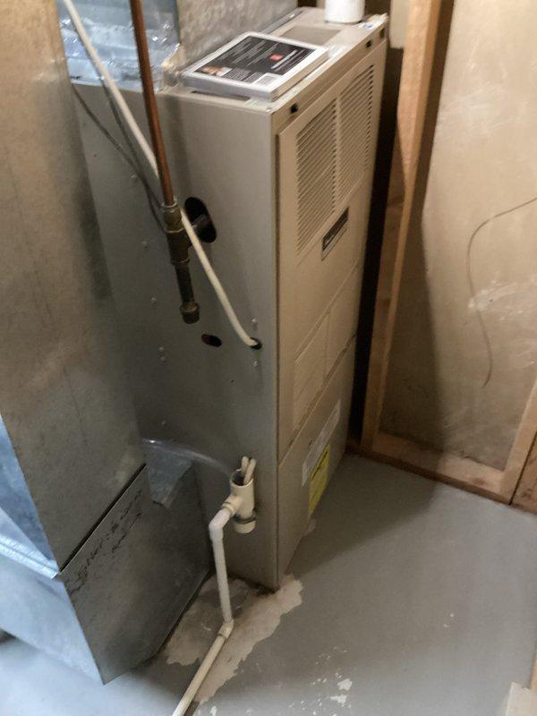 Performed comprehensive tune-up and inspection on a 27-year-old Amana high-efficiency furnace in preparation for home sale inspection. System was experiencing significant noise issues, specifically a loud knocking sound originating from the blower motor assembly.

Conducted thorough safety and operational assessment of all furnace components. Inspected heat exchanger and confirmed safe operation with proper combustion and flame characteristics. Verified burner assembly functioning correctly with appropriate blue flame pattern.

Identified multiple issues during inspection. Discovered blower wheel heavily contaminated with debris and dirt accumulation, causing irregular operation and excessive noise. Found blower motor and wheel assembly improperly supported with styrofoam material, which had been previously installed in an attempt to reduce operational noise. This makeshift support was contributing to system instability and noise generation.

Assessed overall system condition given the