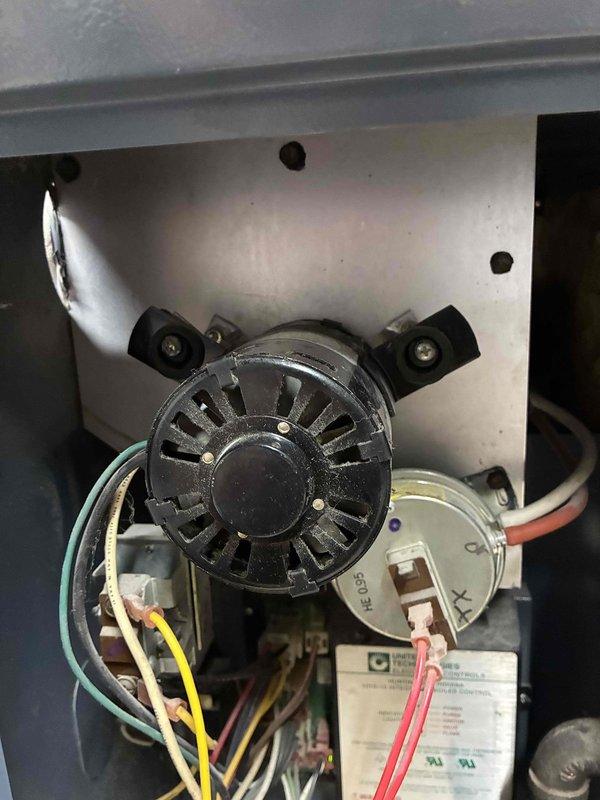 Completed preventive maintenance on boiler system and two air conditioning units. Newer AC unit operating within manufacturer specifications with all electrical components testing normal. Older AC unit electrical systems functioning properly, however R22 refrigerant pressures measured borderline low indicating potential refrigerant loss. Boiler inspection revealed critical components nearing end of service life, including inducer motor showing significant wear and one zone valve end switch failing to make proper contact. Documented all findings with photographic evidence of blower motor assembly and internal components. Provided repair options and boiler replacement pricing to homeowner for consideration, with follow-up appointment scheduled for system upgrade consultation.