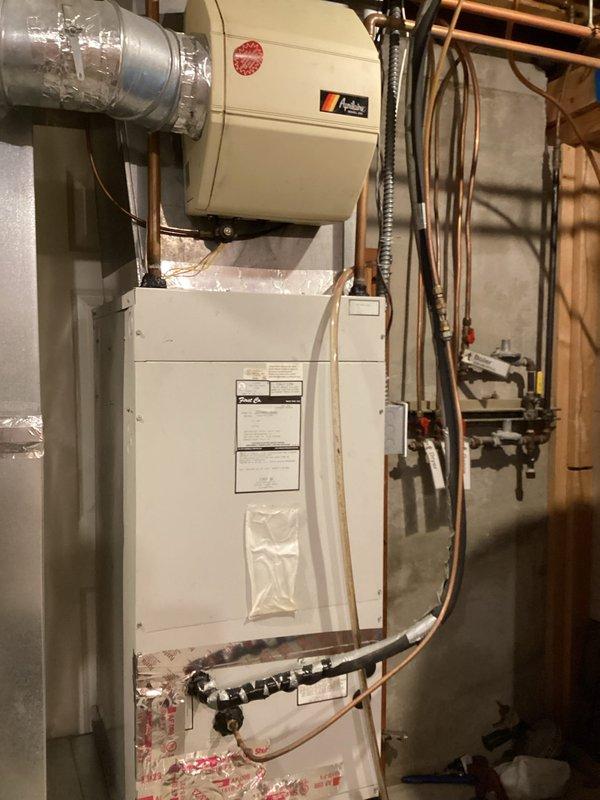 Responded to no heat and no hot water call on a 2009 Triangle Tube Prestige Solo 110 boiler displaying E02 error code indicating ignition failure. Upon inspection, found unit unable to establish ignition and cycle properly. Temporarily achieved ignition by accessing and clearing exhaust vent cap, which indicated restricted venting or heat exchanger fouling. Diagnosed heat exchanger as likely clogged, preventing proper combustion air flow and causing repeated ignition lockouts. Recommended scheduling follow-up service for heat exchanger cleaning or replacement to restore full system operation and prevent continued no-heat conditions.