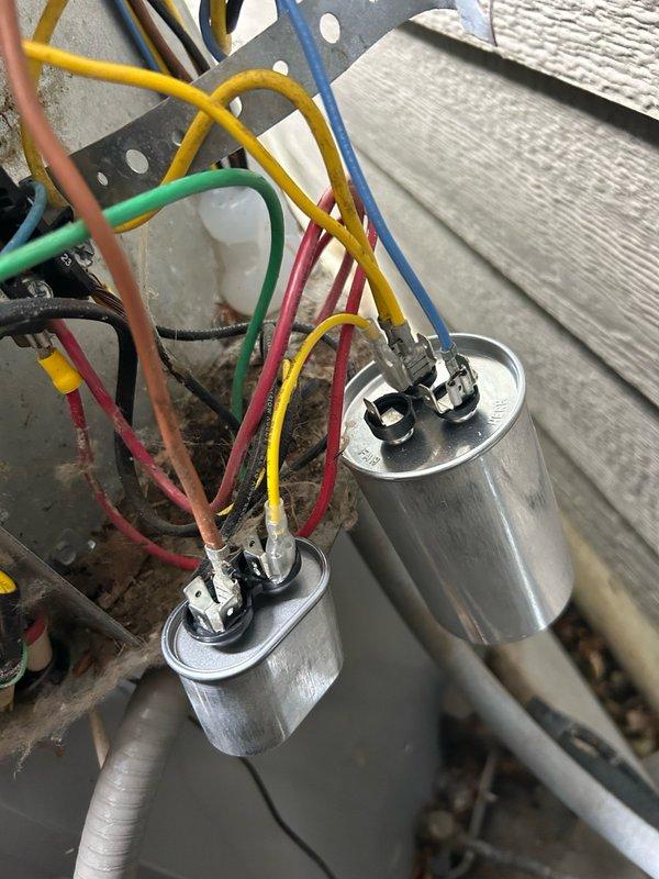 Responded to no cooling complaint on 14-year-old residential air conditioning system. Upon diagnostic evaluation, discovered failed dual-run capacitor reading 26 mfd/0 mfd against rated specification of 45/5 mfd, explaining customer's previous need to manually start condenser fan motor. Replaced defective capacitor with new unit matching OEM specifications. Inspected air filtration system and found heavily soiled pleated filter restricting airflow; installed new replacement filter. Verified condenser operation with system startup, confirmed proper compressor and fan motor function. Checked refrigerant pressures and temperatures, all readings within normal operating parameters. System restored to full cooling capacity with no additional issues identified.