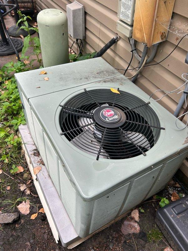 Responded to a no-cooling call on a 30-year-old Rheem system where the indoor blower was operating but no cooling was occurring. Upon inspection of the outdoor condenser unit, diagnosed a failed run capacitor and blown 30-amp fuses preventing compressor operation. Replaced the capacitor and fuses, then attempted to restore power, but the circuit breaker immediately tripped and blew one of the newly installed fuses. Noted that the breaker was abnormally difficult to reset and remove from the panel, indicating a potential fault in the electrical supply system. Determined that the issue extends beyond the HVAC equipment to the electrical infrastructure, specifically the breaker panel and safety disconnect. Recommended and coordinated follow-up with a licensed electrician to diagnose and repair the electrical supply side before the air conditioning system can be safely restored to operation.