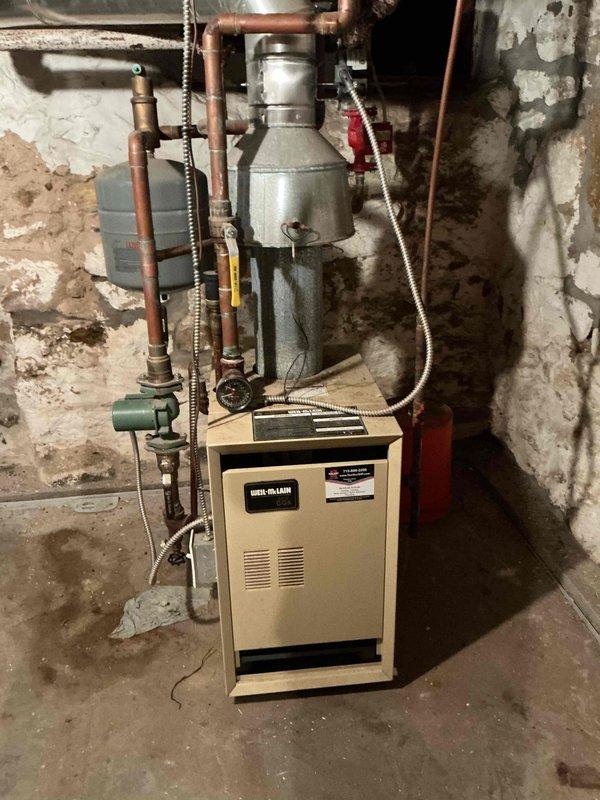 Performed comprehensive boiler tune-up including inspection of heat exchanger, cleaning of all burners, and igniter maintenance. Verified proper operation of all electrical components, then fired unit and checked all radiators throughout the system. Bled air from upstairs bathroom radiator and adjusted system water pressure to proper operating level, restoring full heating functionality.