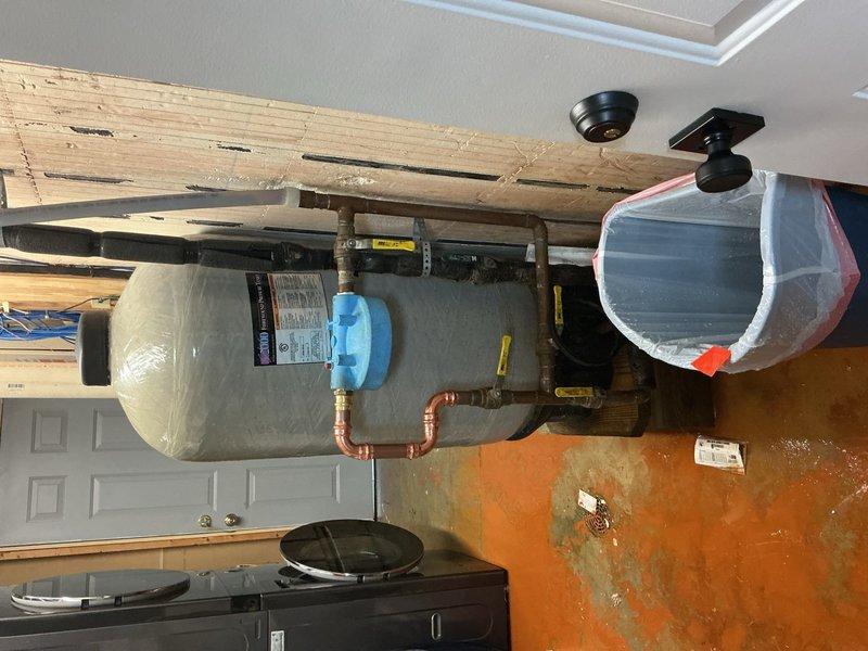 Responded to emergency water line leak located near pressure tank in garage area. Upon arrival, identified burst water line requiring immediate replacement. Removed damaged section of water line and installed new piping with proper copper fittings and secure hose clamp connections. Verified system integrity, restored water pressure, and confirmed no additional leaks present upon completion.