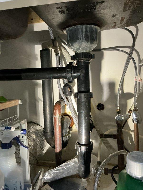 Completed annual plumbing inspection to diagnose ongoing water pressure issues throughout the residence. Upon inspection, identified well casing leak as primary cause of low pressure problem. Examined pressure tank system and associated plumbing connections, documenting corroded copper piping beneath sink fixtures and moisture damage on utility room floor near pressure tank base. Recommended well contractor service to pull pump and repair casing leak. Identified exterior faucet requiring replacement, scheduled for future service visit per homeowner request.