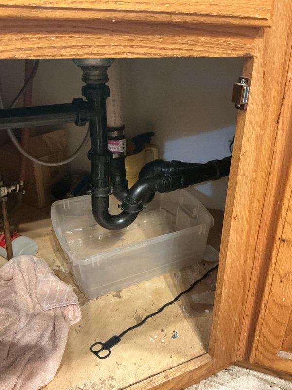 Responded to kitchen sink drain backup issue. Upon arrival, customer had already removed P-trap and attempted to clear blockage with 25-foot snake through pipe into toilet stack without success. Performed professional drain snaking of kitchen sink line to clear obstruction. Verified proper drainage flow and reinstalled plumbing components. Blockage successfully cleared and sink draining normally upon completion.