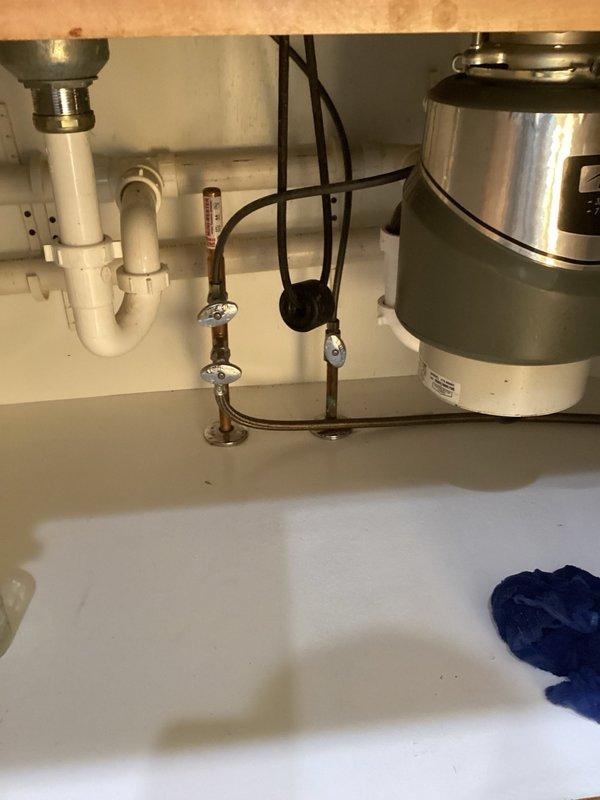Responded to kitchen sink drainage issue with leak under cabinet. Upon inspection, identified that the extension tube connected to the garbage disposal discharge arm was insufficient in length, creating an improper seal and allowing water to leak into the cabinet below. Removed the defective extension tube and installed a properly sized replacement to establish a secure, watertight connection between the disposal and drain assembly. Verified all connections for proper seal and tested system operation to confirm resolution of leak.