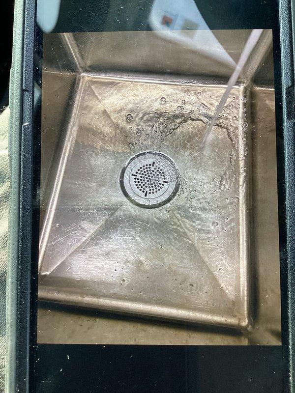 Responded to a commercial sink drain leak caused by a failed basket strainer assembly. Removed the defective strainer and installed a new commercial-grade basket strainer with proper drain assembly connections. Installed chrome drain cover with perforated drainage pattern and connected new P-trap with appropriate rubber couplings to ensure watertight seal. Verified all connections for proper alignment and tested the complete drain system for leaks under full water flow. Cleaned and inspected the work area upon completion. All components functioning properly with no leaks detected. One-year parts and labor warranty provided on installation.