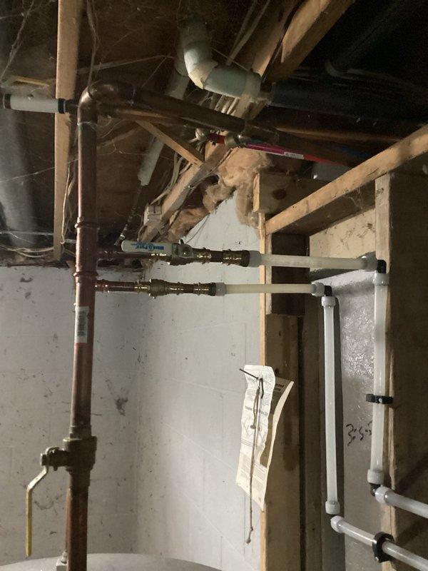 Responded to service call for leaking water heater with visible water accumulation on floor. Upon inspection, identified an 80-gallon U.S. Craftmaster electric water heater actively leaking from the bottom of the tank, indicating internal tank failure. Unit was still producing hot water at time of assessment. Documented existing conditions with photographs showing the water heater installation in basement utility area, copper supply lines, yellow-handled shut-off valve, and water staining on concrete floor surrounding the base of the unit. Provided customer with detailed estimate for complete water heater replacement due to non-repairable tank failure.