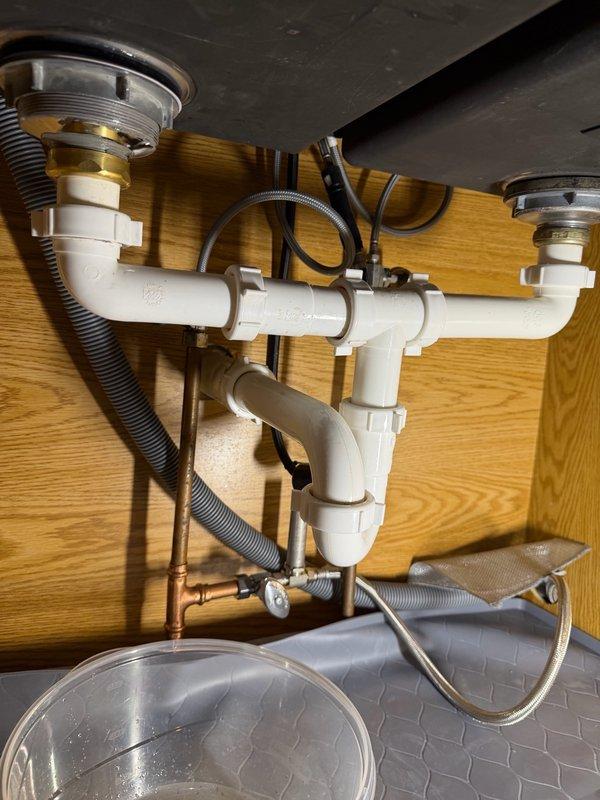 Responded to water leak under kitchen sink. Upon inspection, identified the basket strainer as the source of the leak. Removed the failed basket strainer and installed a new replacement unit. Tested the repair to confirm proper seal and verified no active leaks remain. System restored to full functionality.