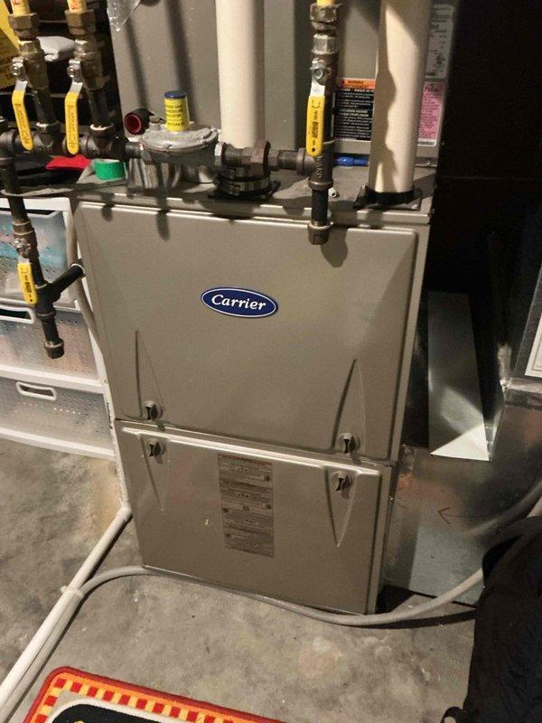 Responded to no cooling call on 13-year-old Carrier central air conditioning system. Upon inspection, discovered the contactor had physically failed at the bottom terminal, causing the wire to detach and create a short circuit that burned the electrical whip. Assessed the damaged whip and determined insufficient wire length remained for proper repair, requiring complete whip replacement along with contactor replacement. Performed compressor winding resistance testing across all terminals to evaluate potential compressor damage from the electrical short. Found resistance readings were approximately equal across all windings, indicating probable compressor damage has occurred. Documented findings with photos of furnace installation and internal mechanical compartment showing electrical connections and components. Reviewed all repair and replacement options with homeowner and coordinated scheduling with service advisor for system evaluation and recommendations.