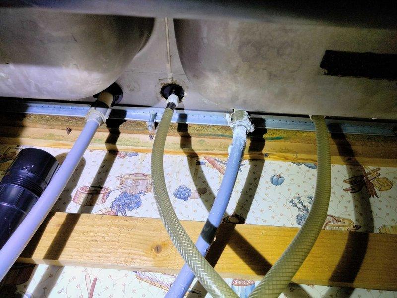 Responded to a water leak emergency underneath a kitchen sink where the supply line was actively leaking and pooling water. The existing plumbing configuration lacked individual shut-off valves at the fixture, requiring the main water supply to the home to be shut off. Installed new angle stop shut-off valves and replaced the deteriorated supply lines with braided stainless steel flexible connectors to both hot and cold water supplies serving the kitchen sink. Upon completion, restored water service and performed a thorough leak inspection to verify all connections were secure and watertight with no signs of dripping or moisture accumulation.